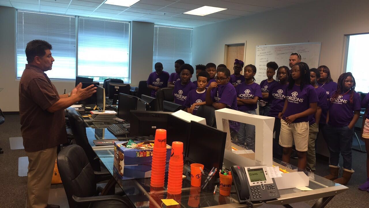 Dr. Johnny Garcia speaks to a group of Horizons Hampton Roads campers gathered in the SimIS office.