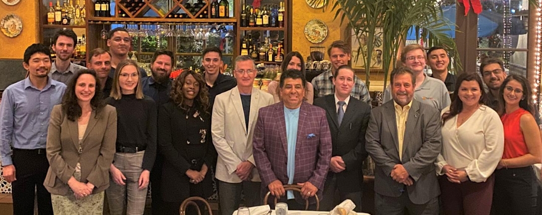Dr. Johnny Garcia and the SimIS team posed together for a group dinner during IITSEC.